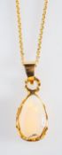 An opal pendant, a pear shaped clear opa