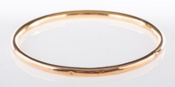 A 9ct yellow gold arm cuff or bangle, UK