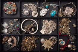 A group of white metal jewellery, including an elephant pendant with opening compartment,