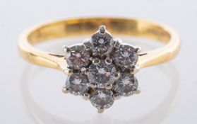 An 18ct yellow gold daisy ring, set with