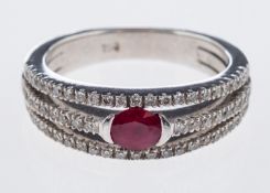 A diamond and ruby ring the central oval