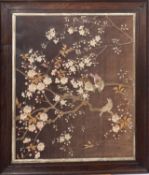 An early 20th century needlework of birds amongst blossom, framed and glazed, 60cm x 49cm.
