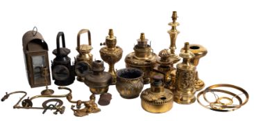 A brass domed carriage lamp with bevelled glass panels, and a collection of various brass lamps.