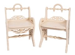A pair of Edwardian later cream painted stools with low turned rail backs and solid seats,