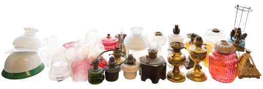 A collection of various oil lamps and shades, etc.