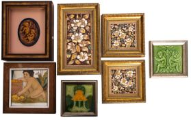 A glazed pottery oval plague depicting cherubs, a glazed pottery tile of kneeling naked child,