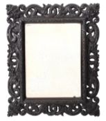 A carved and stained ebonised wood rectangular mirror, late 19th Century,