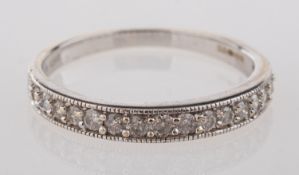 An 9ct white gold half eternity ring, mi