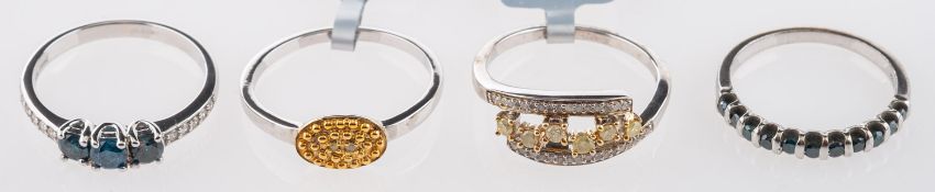 A group of four silver rings, set with b