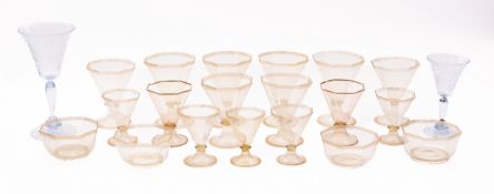 A part suite of nineteen Venetian gilt decorated glasses and bowls and two blue tinted armorial