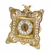 A brass mounted mantel clock having a French eight-day duration timepiece movement with a platform