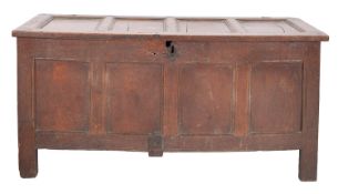 An oak coffer, mid 17th century; with four panel wire-hinged top,