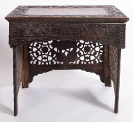 An Indo-Chinese carved and stained wood writing table,