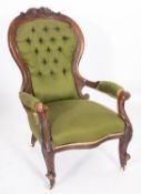 A Victorian carved walnut and upholstered armchair,