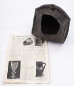 An early 18th century English stitched leather costrel with open spout and two strap holes,