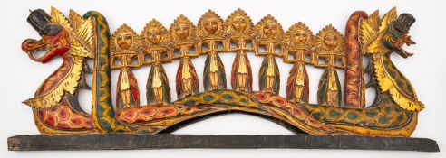 An Indian carved and painted wood transom in the form of eight figures flanked by dragons,