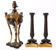 A pair of Louis Philippe bronze and marmo Siena mounted candlesticks,