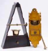 Two painted wood wall brackets for brass mortars and pestles, the brass elements 19th century,