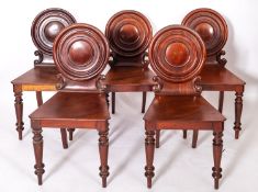 A set of five Regency mahogany hall chairs,