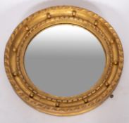A Regency carved and giltwood framed circular convex wall mirror,
