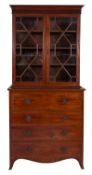 A George III mahogany secretaire bookcase, circa 1810, with moulded cornice and reeded frieze,