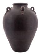 A stoneware Martaban food storage jar, of oviform with five lug handles 46cm high.