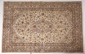 A Kashan carpet, the ivory Arabeque field with a central cartouche pole medallion,