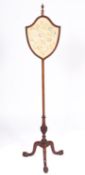 A mahogany and silkwork pole screen in George III style,