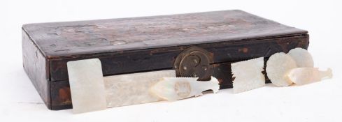 A Chinese black lacquer box, containing mother of pearl gaming counters, box 24cm wide.