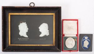 A pair of 19th century white biscuit portrait medallions of Marie Antoinette and Louis XVI,