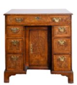 A George II burr walnut and feather banded kneehole desk,
