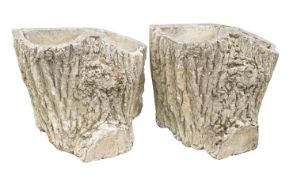 A pair of stone composition strawberry planters, 20th century; modelled as tree trunks,