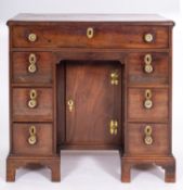 WITHDRAWN LOT A George II mahogany kneehole desk, mid 18th century; the top with moulded edges,