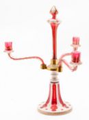 A Bohemian overlay glass three-branch candelabra in white, ruby and clear glass,