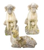 A pair of reconstituted stone groups of hounds with pups,