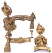 A pair of gilt brass chenets in Louis XVI style,