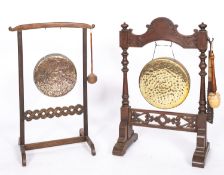 Two Victorian oak mounted brass dinner gongs,
