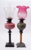 Two Victorian table oil lamps, late 19th century; one with glass flue,