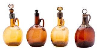 A group of four 19th century amber glass flagon decanters with brass and m.o.p.