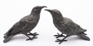A pair of Continental spelter inkwells modelled as birds, early 20th century; portrayed standing,