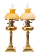 A pair of brass and glass table oil lamps,