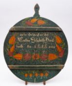 A Continental painted softwood breadboard, Austrian or German, 19th century; of circular form,