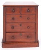 A miniature Victorian mahogany chest of drawers, late 19th century; the top with moulded edges,