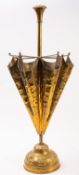 A repousse brass pole stand of umbrella form, circa 1900; modelled as partially opened,