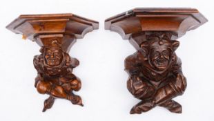 A pair of carved walnut wall brackets,