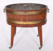 A George III mahogany and brass banded wine cooler,
