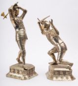 A pair of Continental 'Alpakka silver' and ivory mounted models of knights in combat,