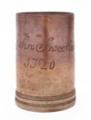A large early 18th Century English dated brown stoneware tankard incised 'John Sweetland 1720',