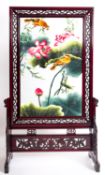 A Chinese carved and stained wood and embroidered room screen,