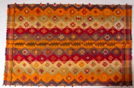 A Tajim kelim, the banded brightly coloured field with geometric medallions, 230cm x 161cm.